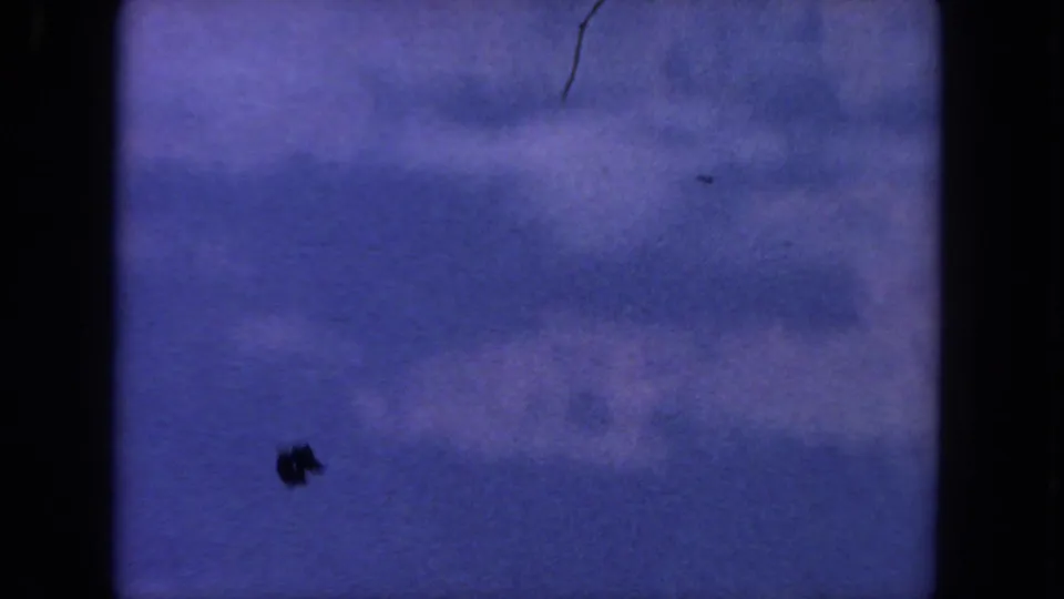 1962 San Diego 8mm frame with a blue sky, pale clouds, dust specks, and dark vertical gate edges.