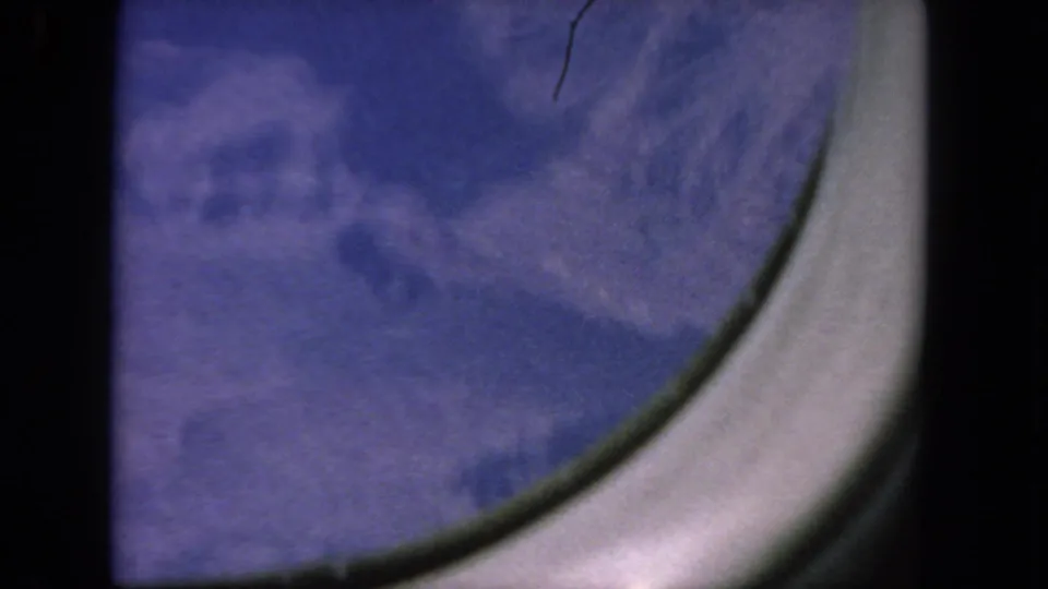 The final 1962 8mm frame shifts to the rounded passenger-window edge, with blue sky and film texture visible.