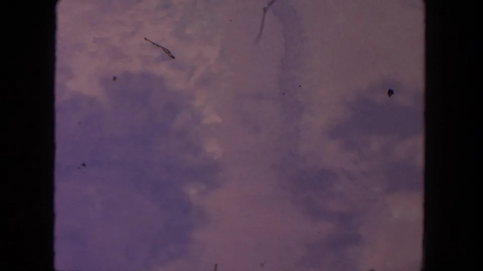1962 8mm San Diego home-movie frame showing muted sky and cloud texture within visible film gate borders.