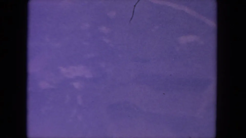Soft 1962 aerial view, likely San Diego, with faint road traces, open-looking areas, grain, gate edges, and visible film wear.