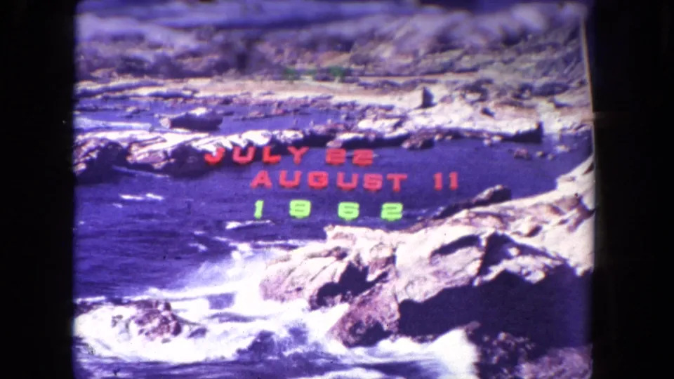 Rocky California coastline with breaking waves and superimposed July 22 to August 11, 1962 vacation dates.
