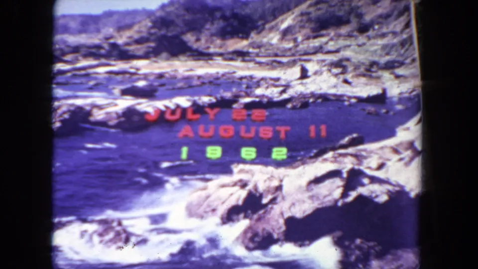 Rocky San Diego-area coastal scene with surf and colored date lettering identifying the 1962 vacation span.