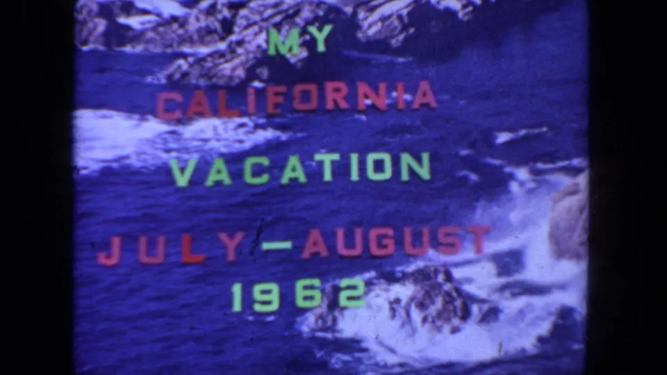 1962 California vacation home-movie title card with red and green lettering over a rocky blue ocean backdrop.