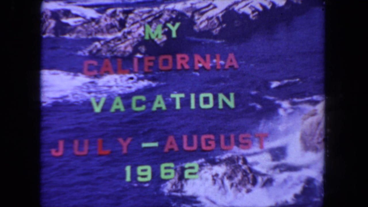 Duplicate frame of the vacation title card with red and green text over ocean water.