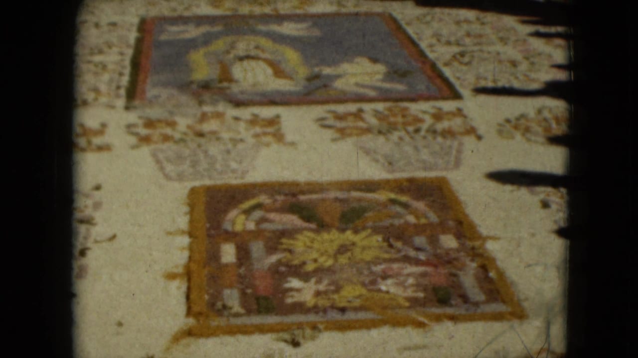 A faded 8mm view of religious textile art panels in Mexico City, with one panel showing a reclining or haloed figure.