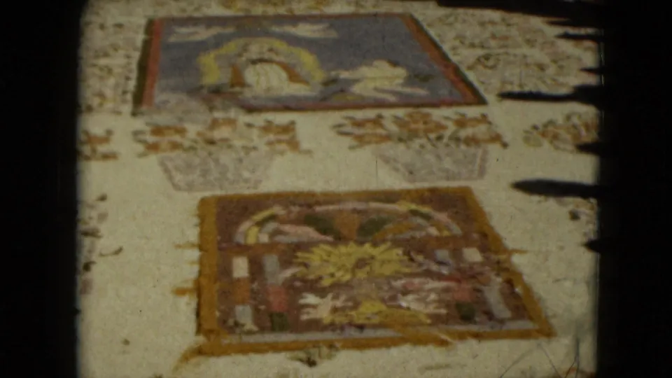 A faded 8mm view of religious textile art panels in Mexico City, with one panel showing a reclining or haloed figure.