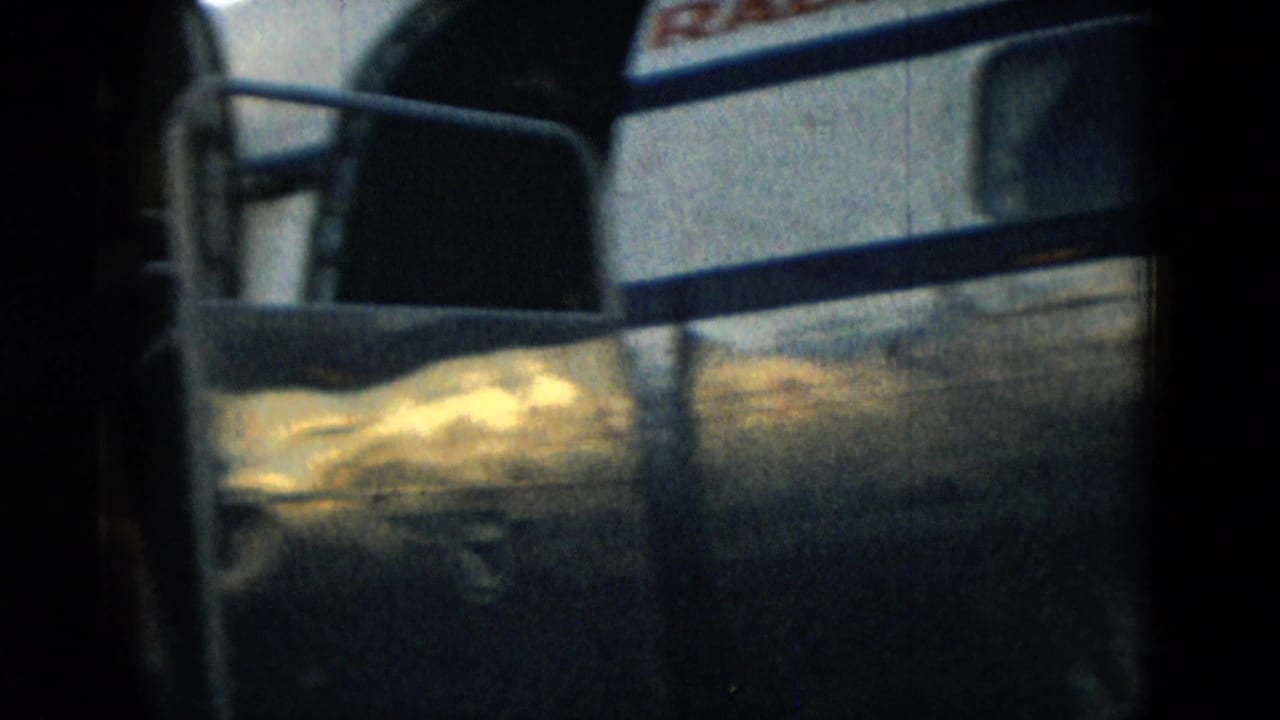 Close view of an airplane fuselage with stair railing and partial airline marking visible.