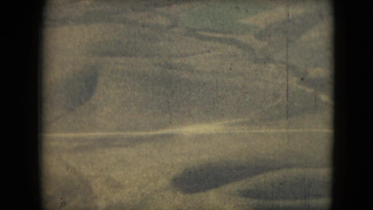 Grainy textured surface divided by a dark vertical band and soft horizontal light.