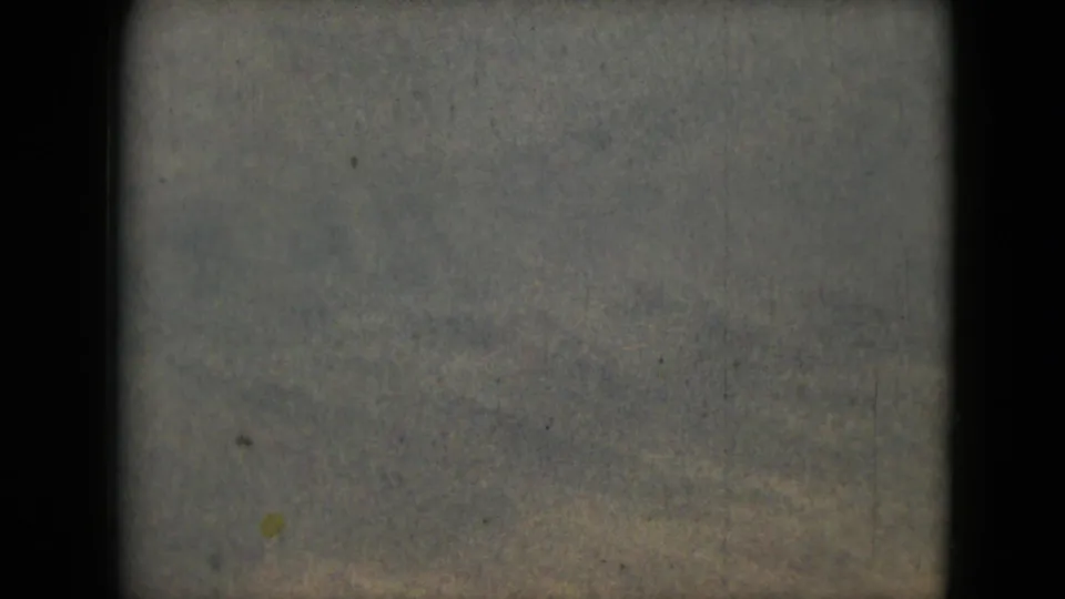 A hazy 1962 8mm landscape view from the Mexico City metadata, showing distant terrain, rough foreground, and visible film texture.