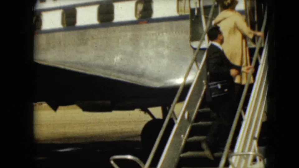 Near the end of the clip, the two adults approach the aircraft doorway on mobile stairs at the Mexico City airport tarmac.