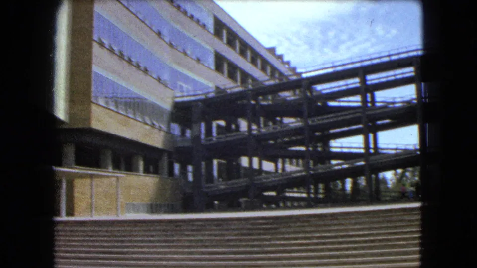 1962 Mexico City footage showing a modernist building facade, exterior stairs, and elevated walkway against a bright sky.