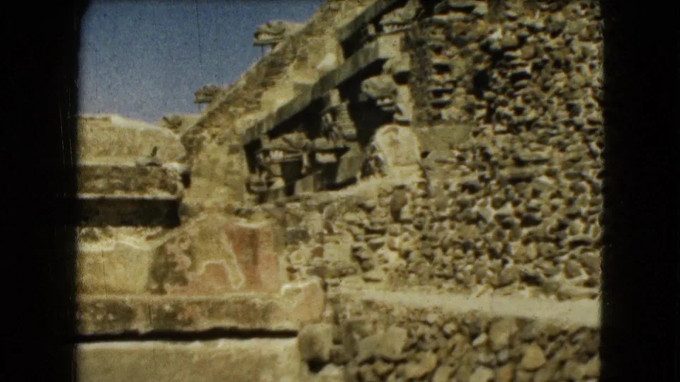 8mm travel frame from the Teotihuacan area showing rough stone walling, carved-looking masonry, and adjacent ruins.