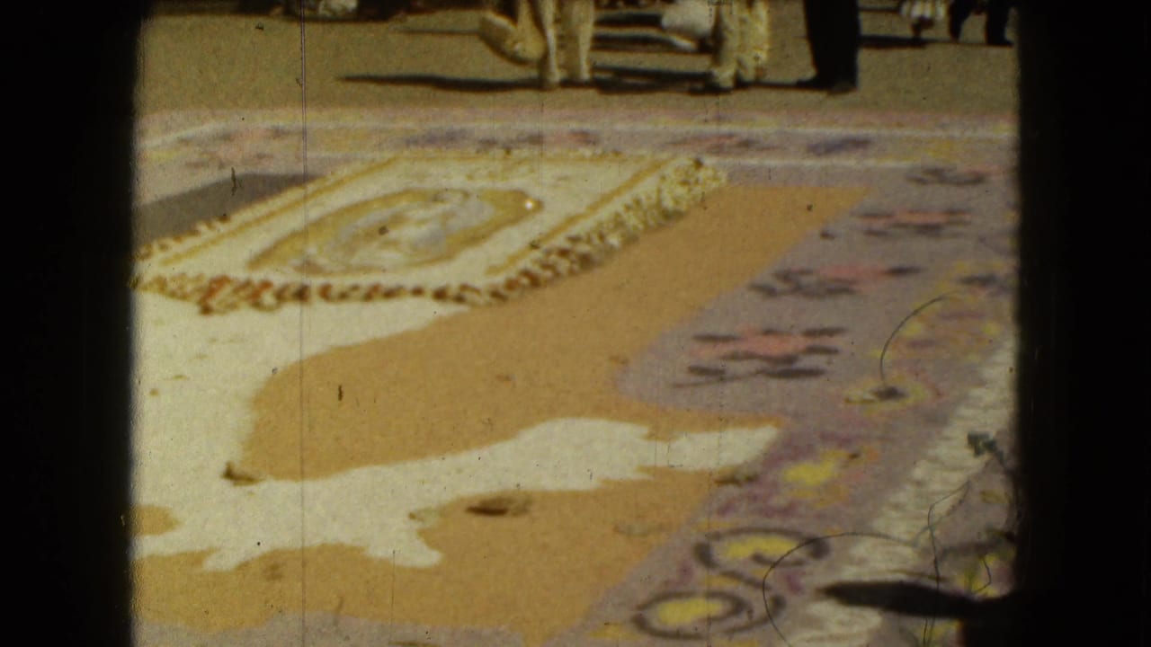 Yellow patterned textile laid on pavement beside dark film borders.