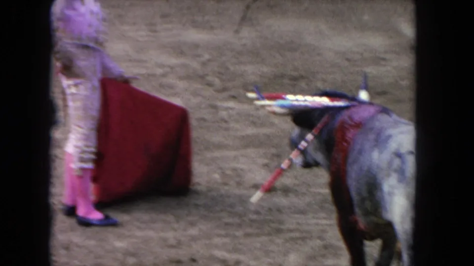 1962 Los Angeles 8mm frame with the bloodied bull near the matador's red cape at the edge of the shot.