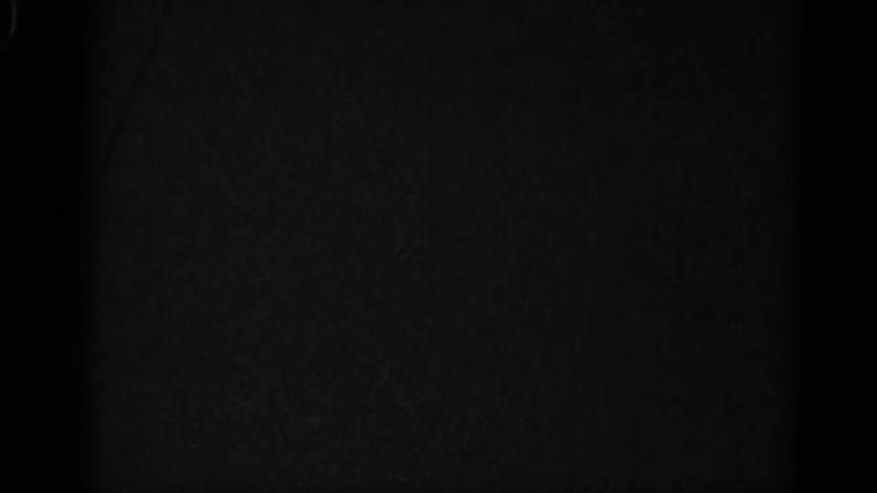 Near-black 8mm frame at clip end; possibly end-of-reel exposure or the camera panning to a dark subject.