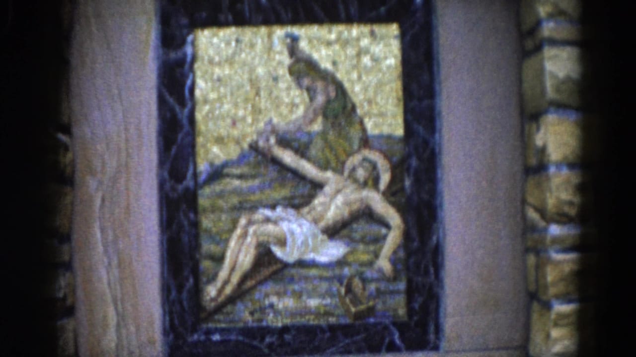 Framed Lamentation of Christ mosaic with gold tessera background, dark stone surround, and wooden pilasters on either side.