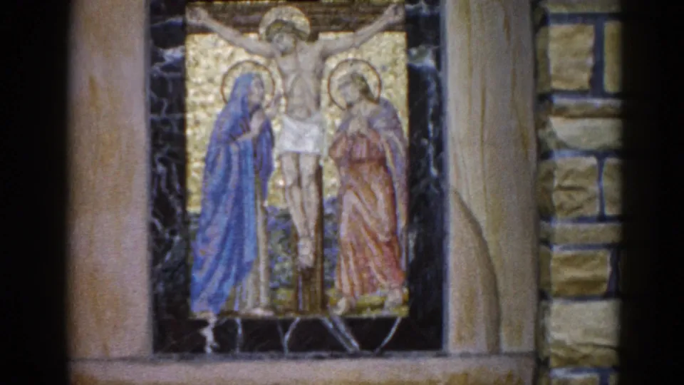 Crucifixion mosaic in an Illinois church interior, ca. 1962; this frame reveals more of the stone surround and pilasters than the previous shot.