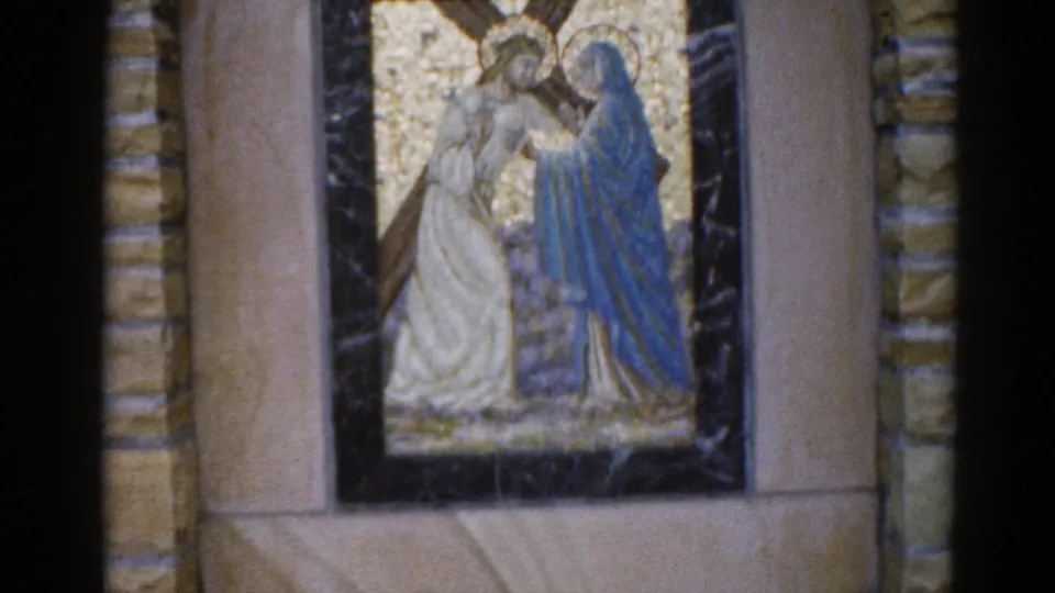 Church mosaic panel, Illinois, c.1962; haloed figures in white and blue robes on gold tesserae, dark marble frame and ashlar stone wall visible at edges.