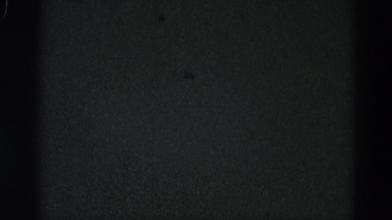 Dark film leader frame with no discernible subject.