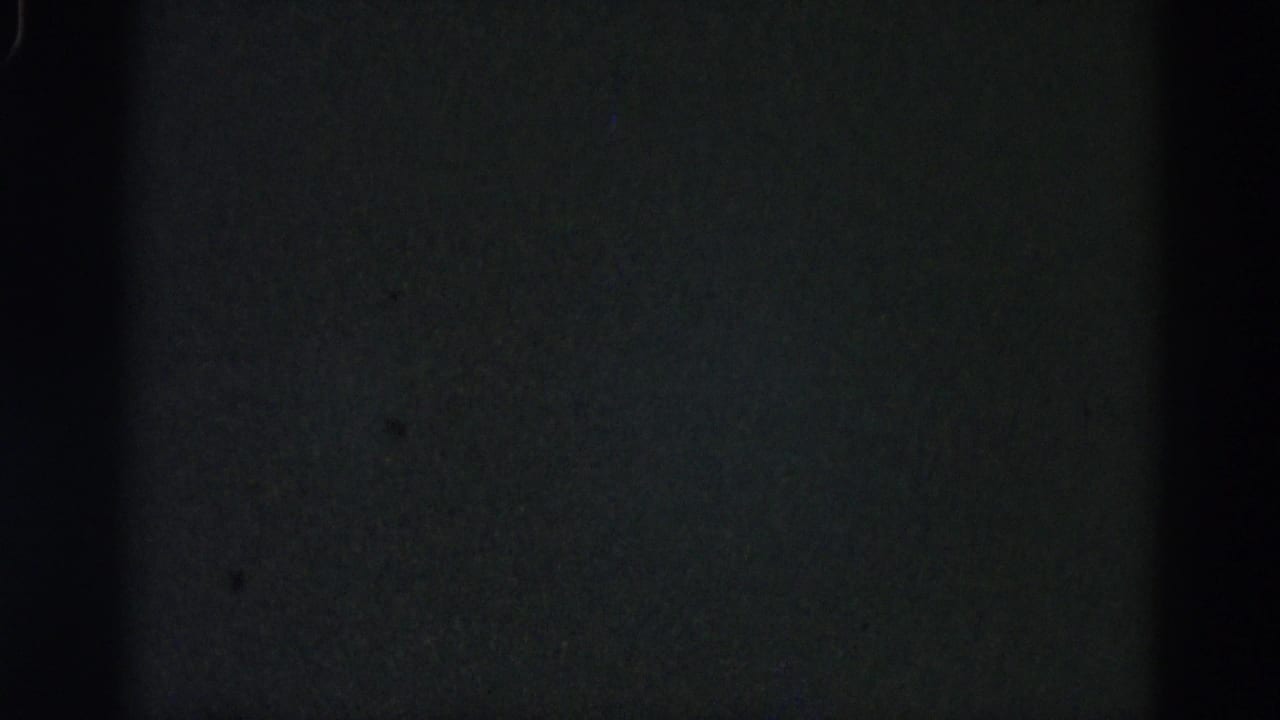 Severely underexposed or damaged 8mm film frame from a 1962 Illinois home-movie reel; no subjects visible, only dark grain.