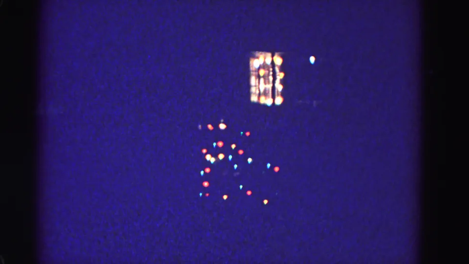 Multicolored Christmas tree lights and house window glow on a winter night, 8mm film, Hagerstown Maryland, circa 1962