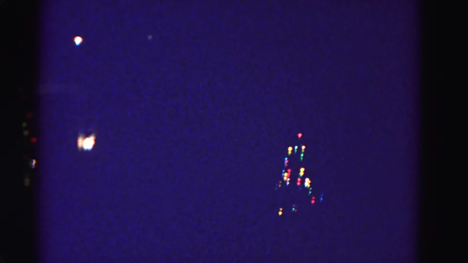 Residential Christmas tree decorated with colored bulb lights, photographed at night from a distance, Hagerstown, Maryland area, circa 1962.