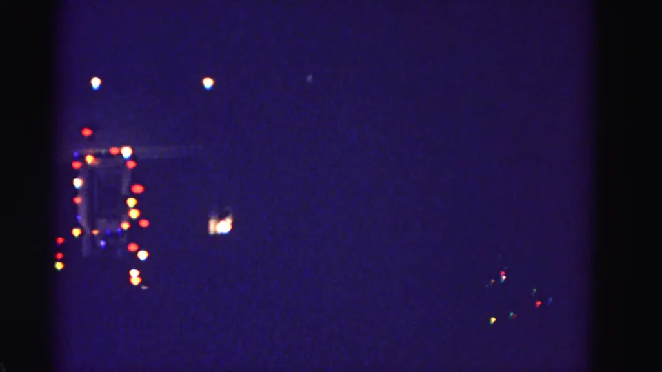 Multiple residential Christmas light displays seen at night across a panned view, Hagerstown, Maryland area, circa 1962.