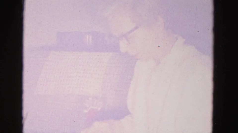 Heavily faded 8mm frame showing a woman and patterned couch nearly lost to extreme overexposure or chemical degradation, Hagerstown, Maryland, c.1962.