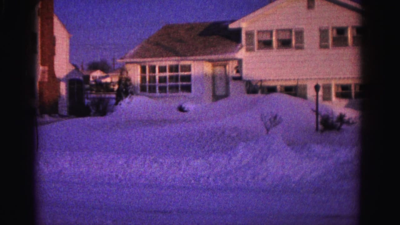 1962 8mm home movie of a two-story white clapboard house in Hagerstown, Maryland, nearly obscured by large snow banks on a clear winter day.