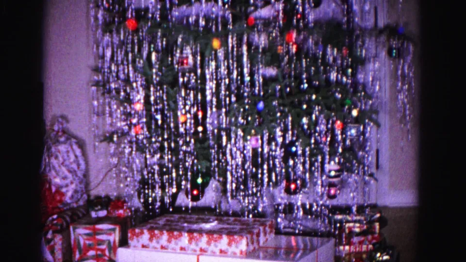 1962 8mm home movie: Christmas tree with cascading tinsel, colorful ornaments, and wrapped presents at the base, Hagerstown, Maryland.