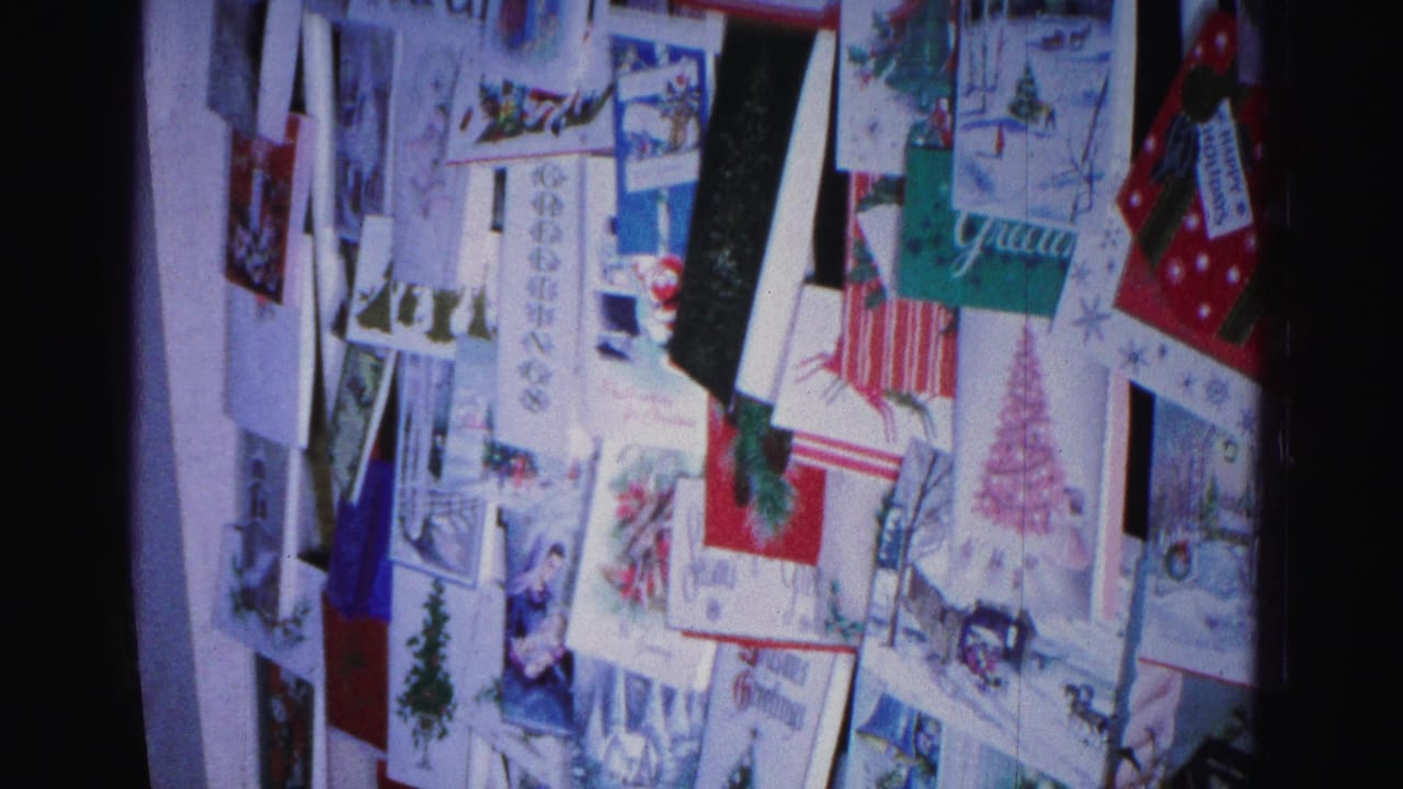 A wall densely covered with Christmas greeting cards in varied colors and designs; no people visible.