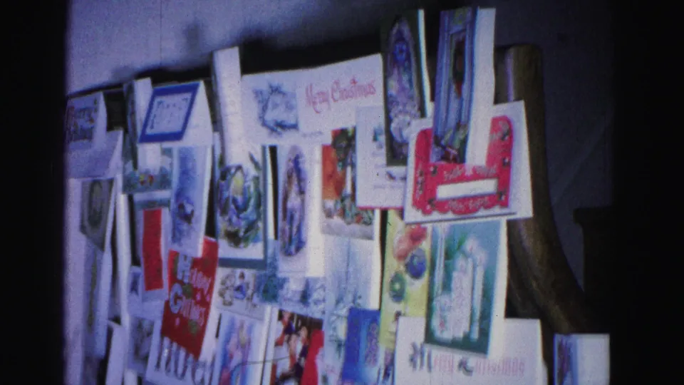 Wall display of Christmas greeting cards with holiday illustrations and text including Merry Christmas, in a home interior circa 1962 Hagerstown Maryland