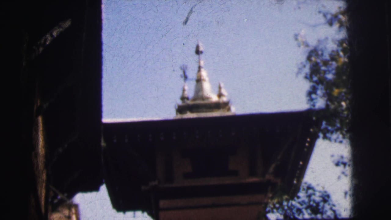 Hindu temple spire and dark stone architectural overhang, likely Calcutta, India, circa 1962, from 8mm home movie footage.