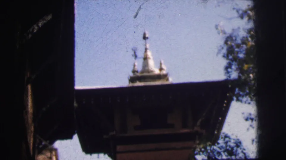 Hindu temple spire and dark stone architectural overhang, likely Calcutta, India, circa 1962, from 8mm home movie footage.