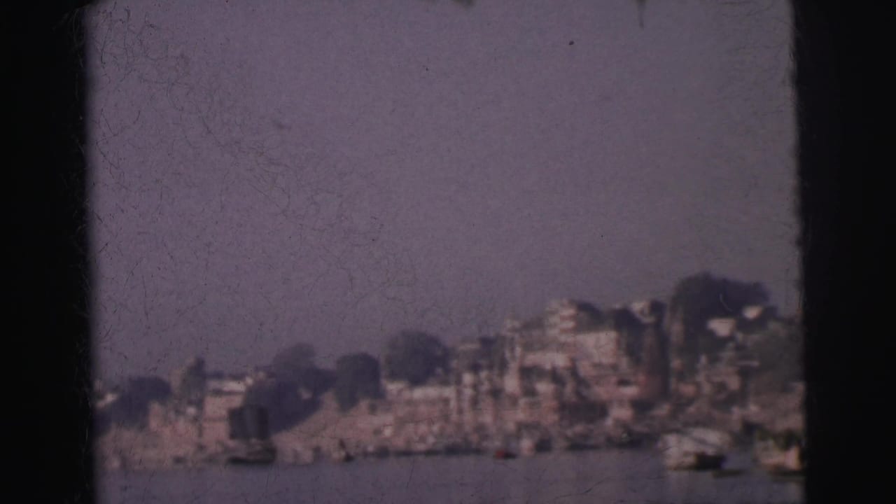 Calcutta waterfront seen from the river, 1962 — multi-story buildings and ghat structures stretching along the far bank under a pale hazy sky