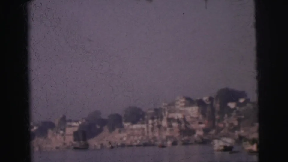 Calcutta waterfront seen from the river, 1962 — multi-story buildings and ghat structures stretching along the far bank under a pale hazy sky