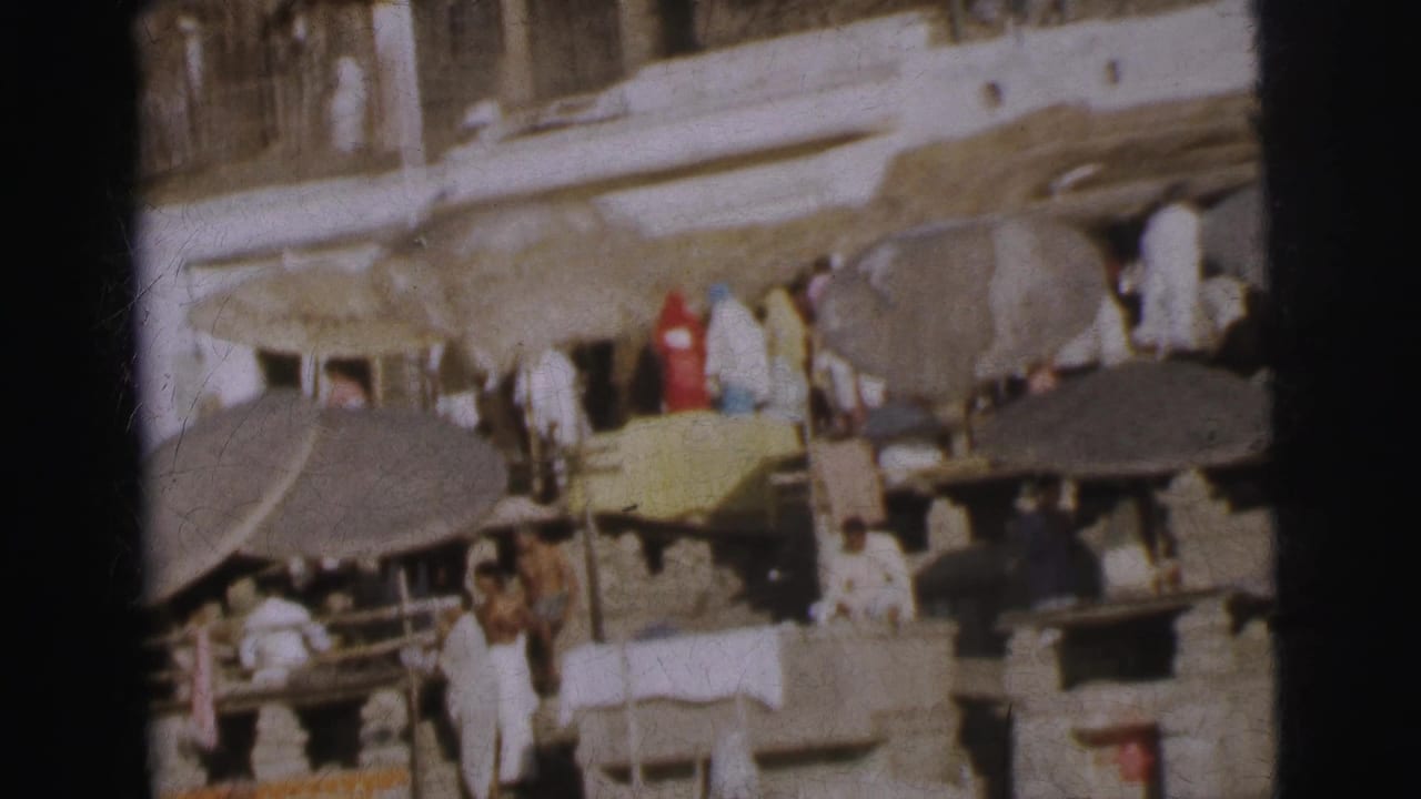 Worshippers and vendors on terraced stone ghat steps under shade canopies, Calcutta riverside, circa 1962, 8mm colour film.