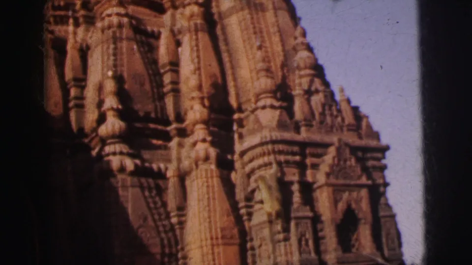 Mid-tower view of carved stone temple shikhara with clustered columns and decorative projections, Calcutta, 1962.