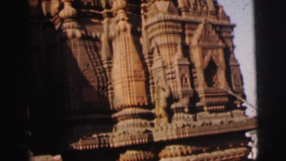 Lower section of ornate temple wall with carved figures in niches and horizontal decorative banding, Calcutta, 1962.