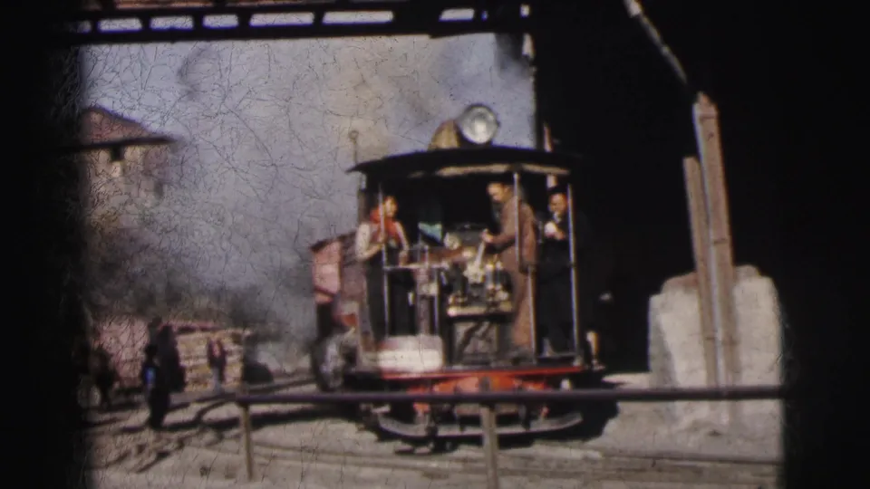 Close head-on approach of narrow-gauge steam locomotive with crew in open cab and stone lineside structures, Calcutta India circa 1962, 8mm home movie