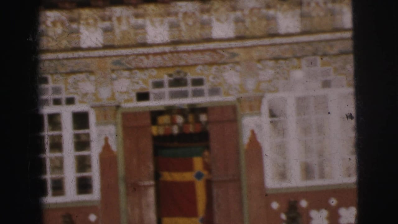 Exterior of an ornate building in Calcutta, India, circa 1962, showing a colorfully banded doorway and white floral motifs on the facade; no figures present.
