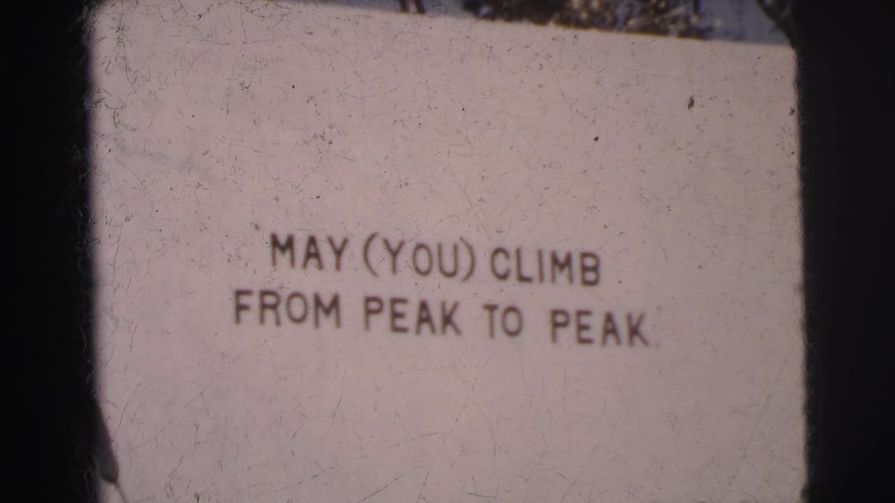 Closer view of the sign text MAY (YOU) CLIMB FROM PEAK TO PEAK.