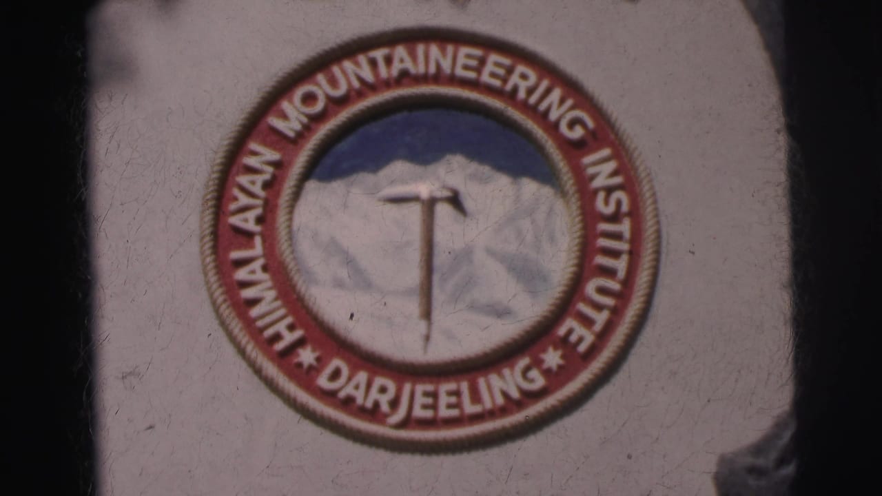 1962 8mm close-up of the Himalayan Mountaineering Institute Darjeeling emblem with mountain and ice axe design.