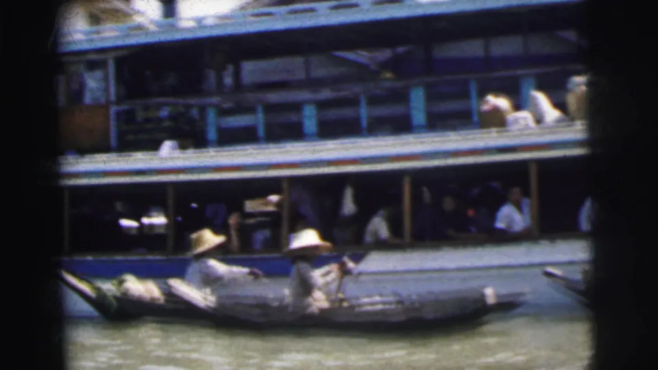 The Calcutta river scene shows a larger passenger vessel with people aboard and a smaller boat alongside in bright sun.