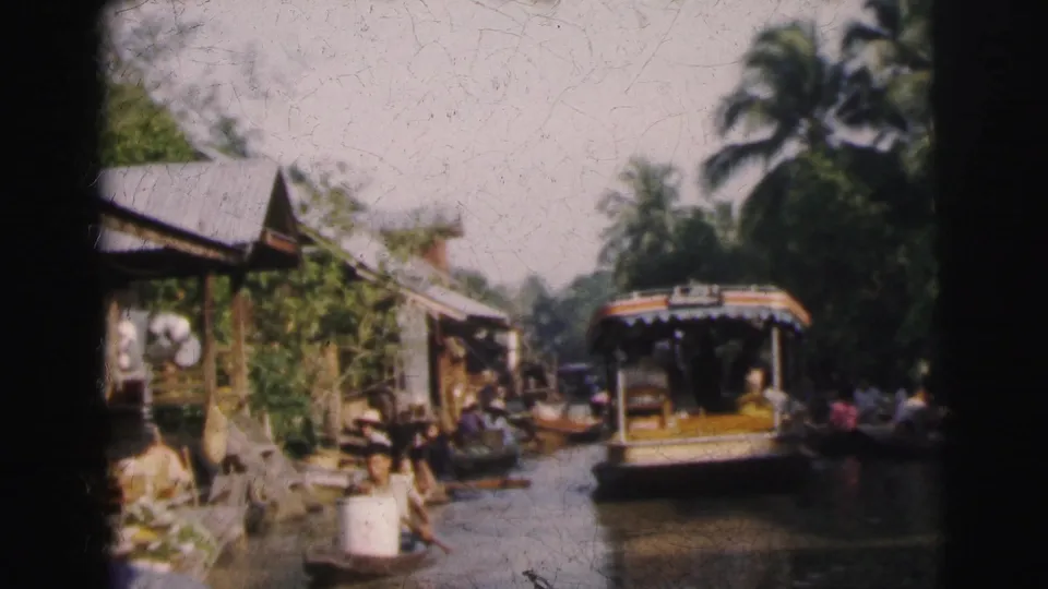 The 1962 Calcutta canal view shows a larger passenger boat near wooden buildings, greenery, and smaller boats along the waterway.