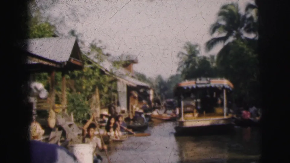 A wider 1962 Calcutta canal frame shows passenger and small boats passing between foliage, palms, and waterway structures.