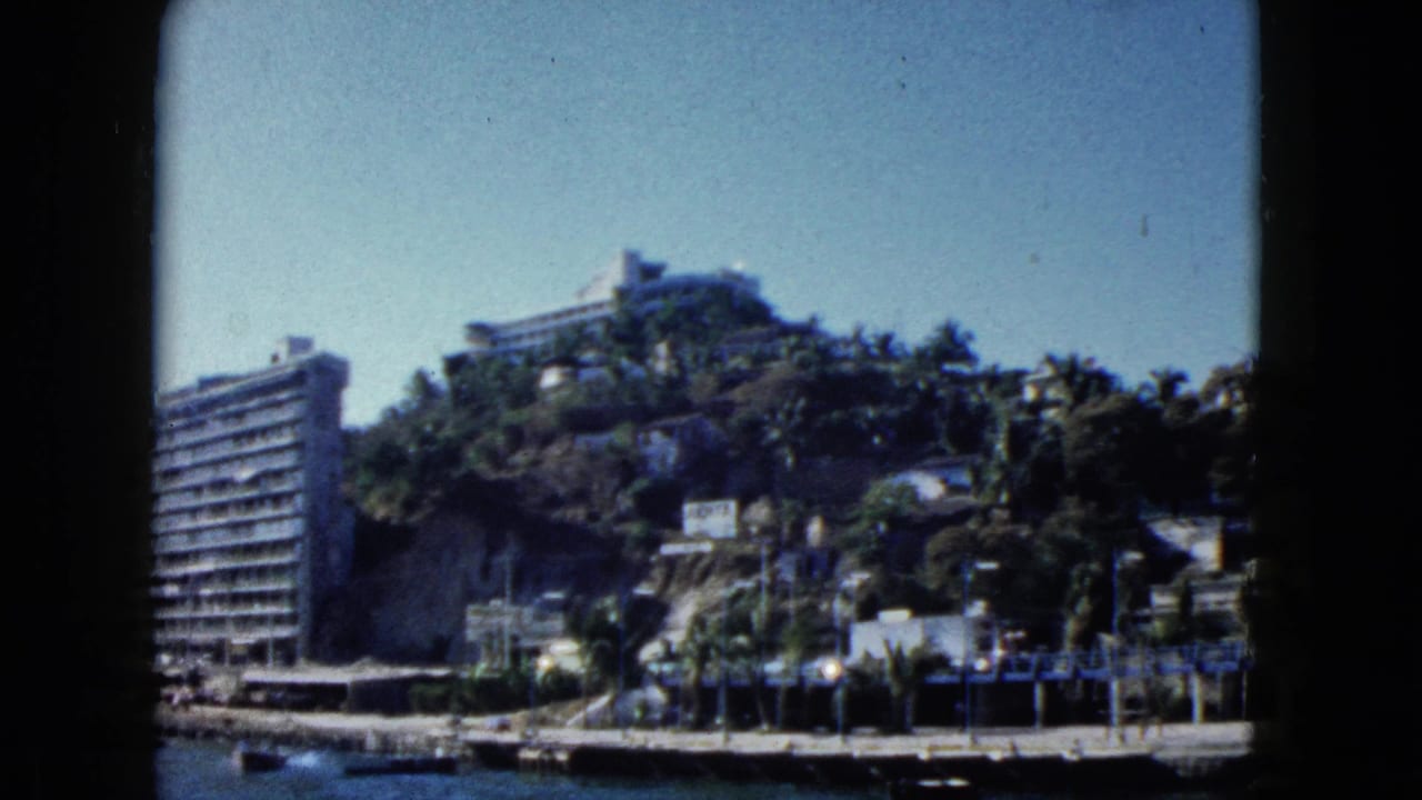 Acapulco, Mexico, 1962: same hillside hotel from a slightly different angle, with palms and dock visible below.