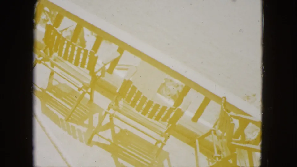 Heavy dye fade renders a multi-story building with open balconies in monochromatic yellow tones; may show a hotel or restaurant near the Acapulco overlook, circa 1962.