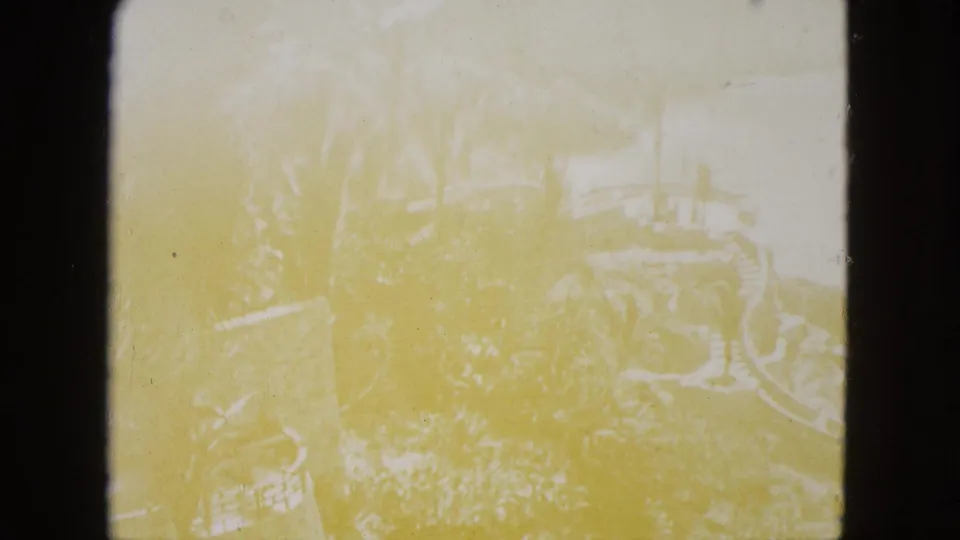 Faded opening frame from 1962 Acapulco footage, with the rocky coast and palm-lined overlook barely visible through heavy exposure bloom.
