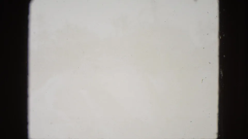 Blank white end-of-reel frame from 8mm home movie film, typical of original 1960s film reels running out.